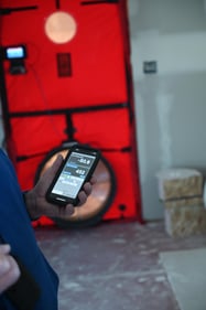 Phone showing Air Changes per Hour (ACH) measured during a blower door test of a SIP built house